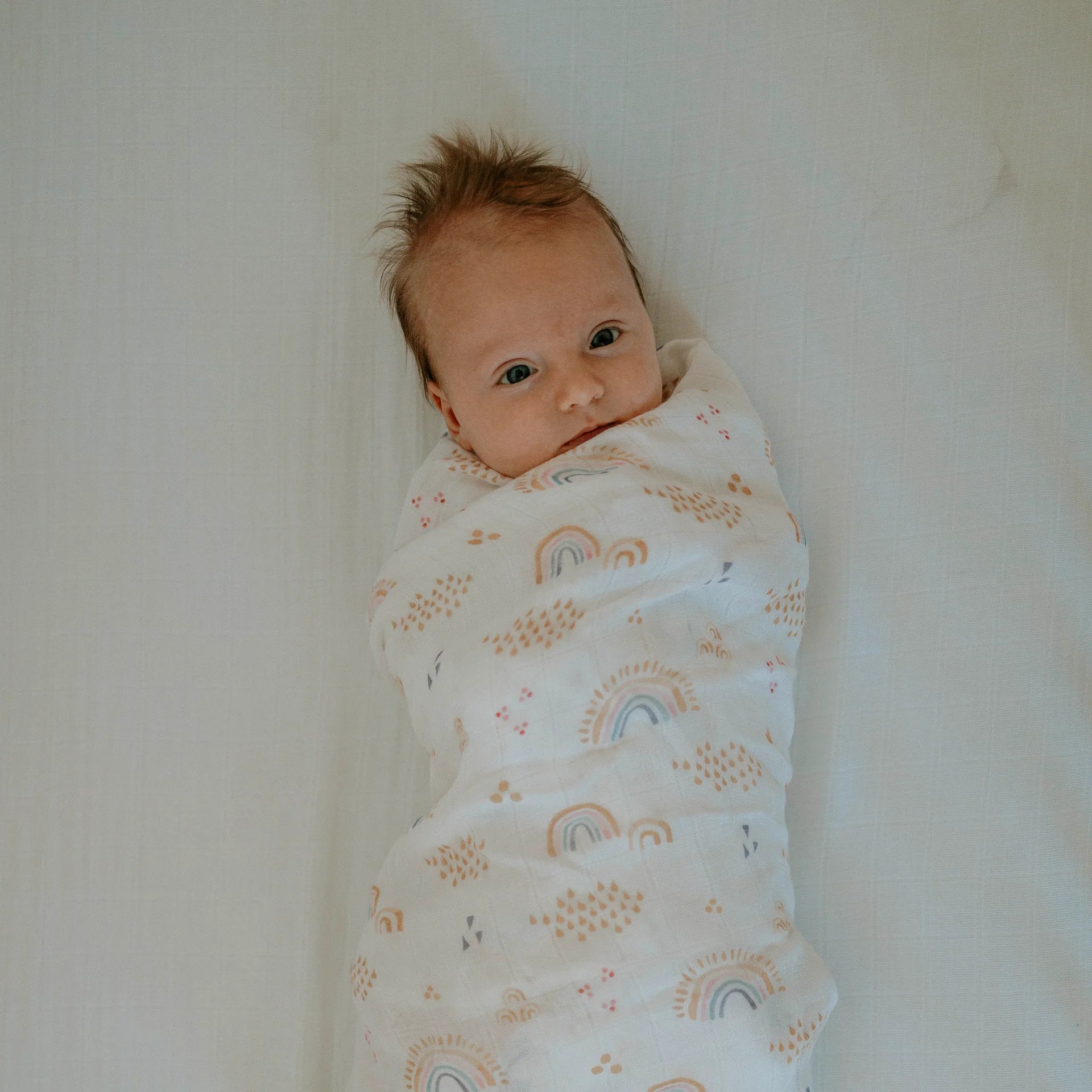 Little Unicorn Deluxe Muslin Swaddle (Rainbows & Raindrops)