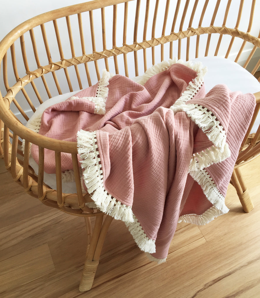 over the dandelions muslin blanket with tassels in shell pink